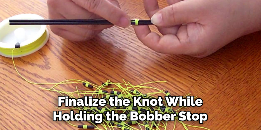 Finalize the Knot While Holding the Bobber Stop